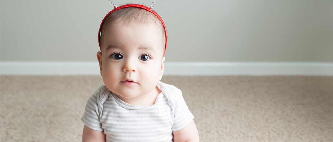 Baby wearing a headband with springy hearts