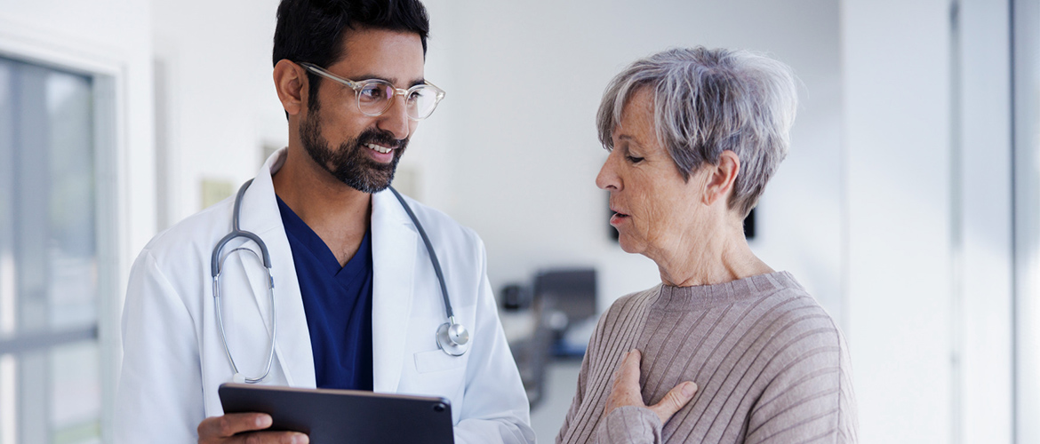 Doctor shows information to older female patient