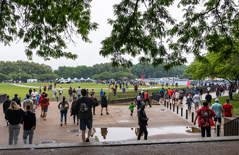 NASCAR fans walk through a downpour at the Chicago Street Race