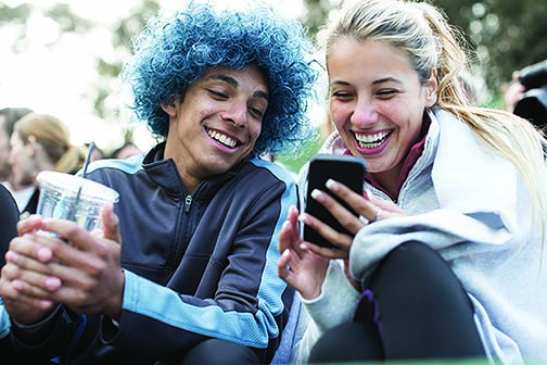 Young couple smiling at a phone screen